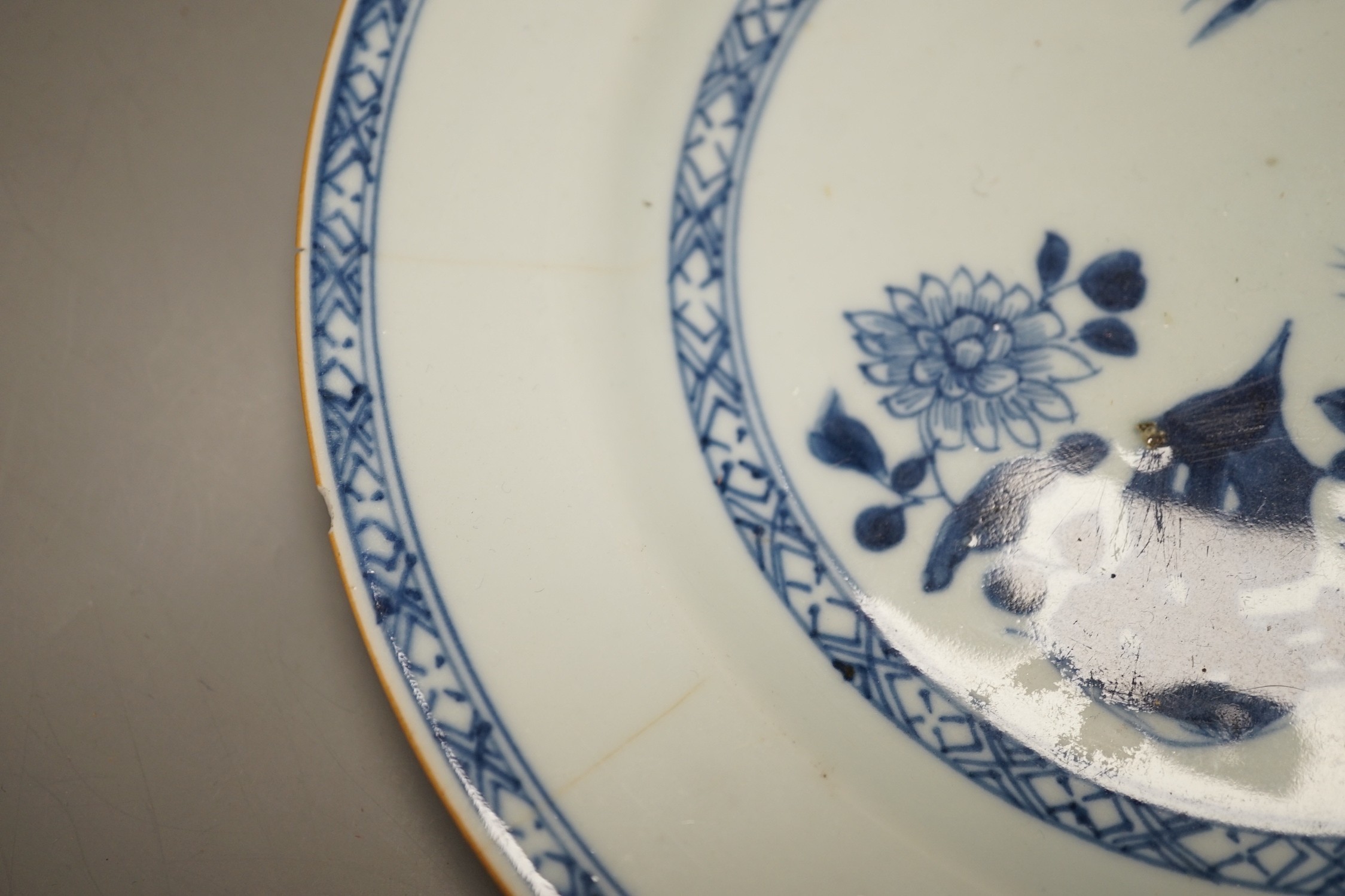 Four Chinese 18th century plates and a late 19th century blue and white dragon plate, largest 24cm diameter